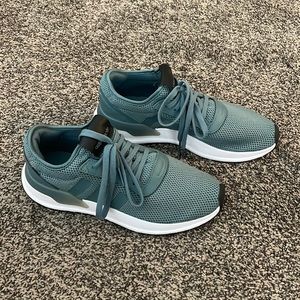 Green adidas running shoes